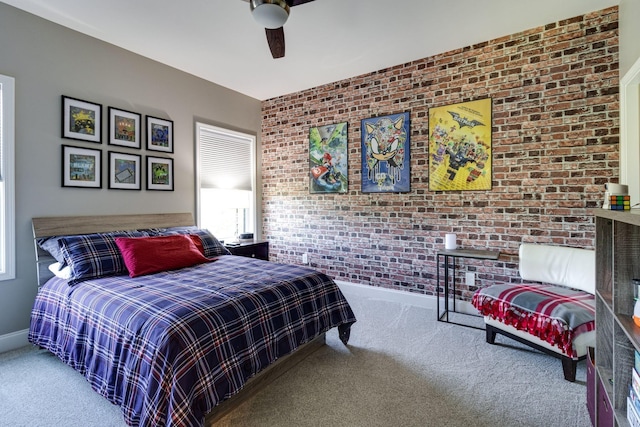 carpeted bedroom featuring brick wall, baseboards, and ceiling fan