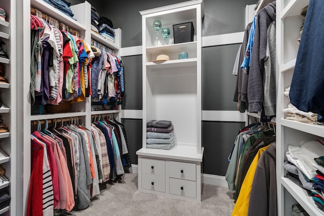 walk in closet featuring light colored carpet