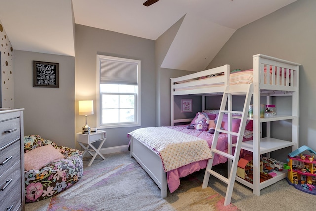 carpeted bedroom with vaulted ceiling and baseboards