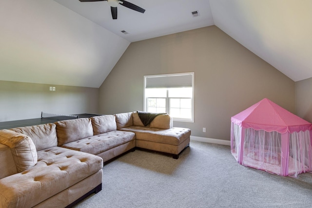 carpeted living area with ceiling fan, vaulted ceiling, visible vents, and baseboards