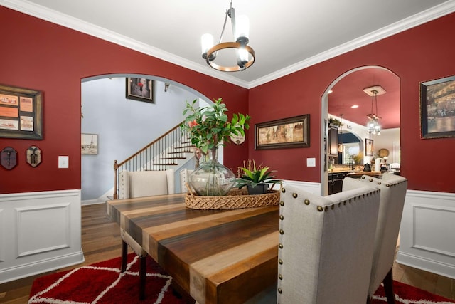 5000 Moretto Ct, Spring Hill, TN 37174 - dining room with stairs, arched walkways, an inviting chandelier, and a wainscoted wall
