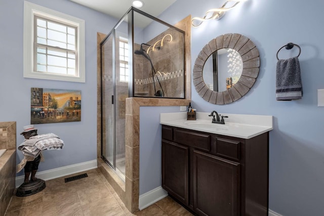 5000 Moretto Ct, Spring Hill, TN 37174 - bathroom featuring tile patterned flooring, vanity, baseboards, visible vents, and a stall shower