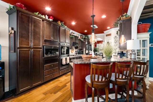5000 Moretto Ct, Spring Hill, TN 37174 - kitchen with recessed lighting, appliances with stainless steel finishes, hanging light fixtures, and dark brown cabinets
