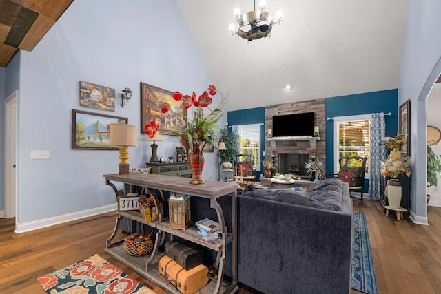 5000 Moretto Ct, Spring Hill, TN 37174 - living room with baseboards, arched walkways, wood finished floors, and a chandelier