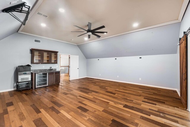 5000 Moretto Ct, Spring Hill, TN 37174 - living area featuring beverage cooler, wet bar, lofted ceiling, a ceiling fan, and dark wood-style flooring