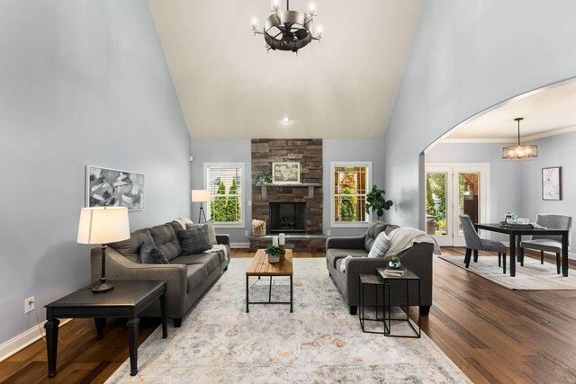5000 Moretto Ct, Spring Hill, TN 37174 - living room featuring a chandelier, arched walkways, high vaulted ceiling, plenty of natural light, and wood finished floors
