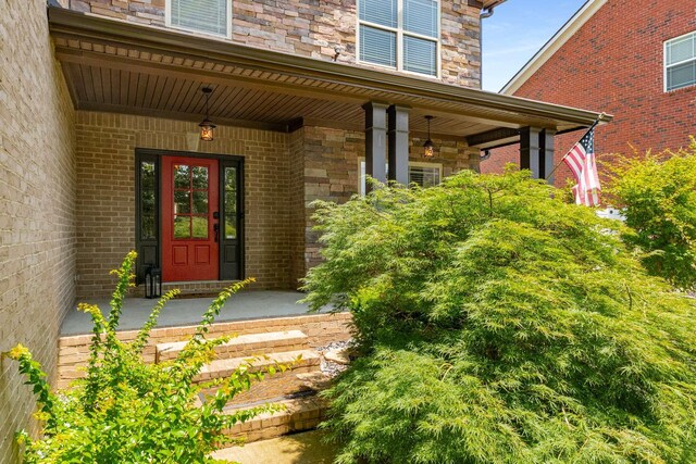 5000 Moretto Ct, Spring Hill, TN 37174 - property entrance with covered porch, stone siding, and brick siding