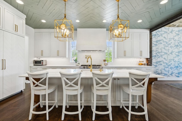 6124 Montcrest Dr, Nashville, TN 37215 - kitchen featuring light countertops, dark wood-type flooring, custom exhaust hood, and an inviting chandelier