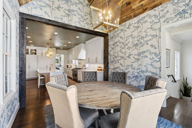 6124 Montcrest Dr, Nashville, TN 37215 - dining space with crown molding, wallpapered walls, a chandelier, and dark wood-style flooring