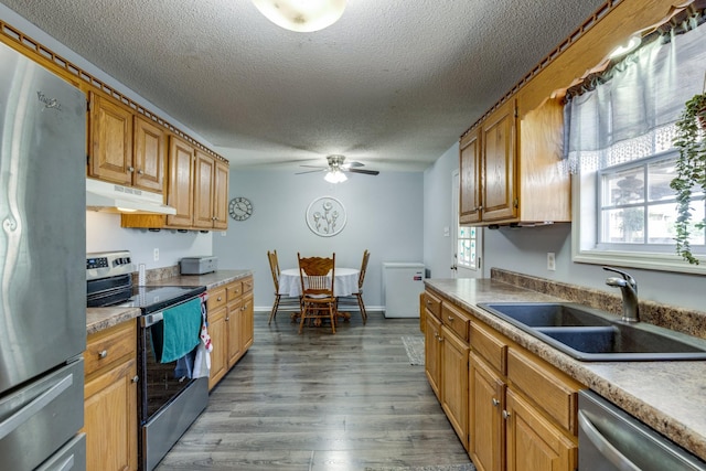 1496 Wade Brown Rd, Lewisburg, TN 37091 - kitchen with ceiling fan, a textured ceiling, under cabinet range hood, a sink, and appliances with stainless steel finishes