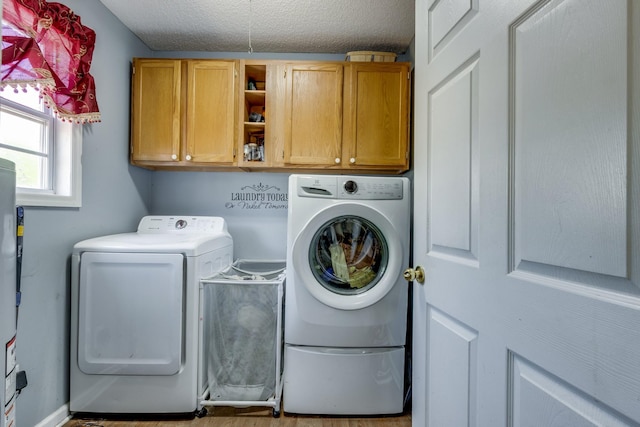 1496 Wade Brown Rd, Lewisburg, TN 37091 - laundry area featuring cabinet space, separate washer and dryer, a textured ceiling, and gas water heater