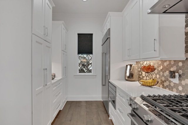 1024 Club View Dr Unit A101, Gallatin, TN 37066 - kitchen featuring white cabinets, backsplash, wall chimney exhaust hood, and built in appliances