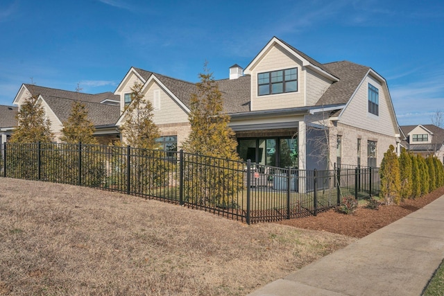 1024 Club View Dr Unit A101, Gallatin, TN 37066 - view of front facade with brick siding, fence private yard, a shingled roof, and a front yard