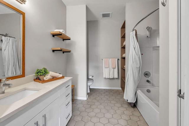 1900 12th Ave S Unit 219, Nashville, TN 37203 - bathroom with vanity, shower / bath combination with curtain, toilet, tile patterned flooring, and visible vents