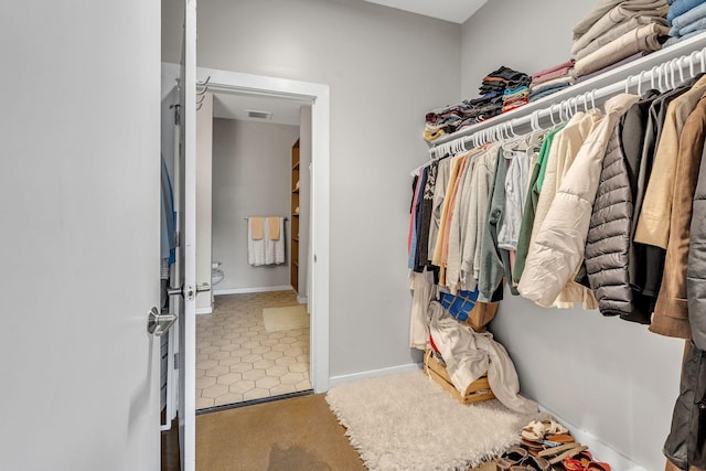 1900 12th Ave S Unit 219, Nashville, TN 37203 - walk in closet featuring carpet floors and visible vents