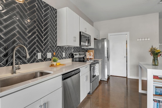 1900 12th Ave S Unit 219, Nashville, TN 37203 - kitchen featuring decorative backsplash, light countertops, a sink, and appliances with stainless steel finishes