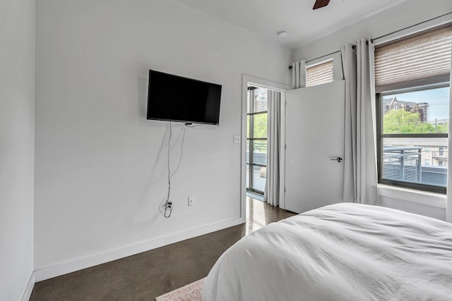 1900 12th Ave S Unit 219, Nashville, TN 37203 - bedroom featuring baseboards and ceiling fan