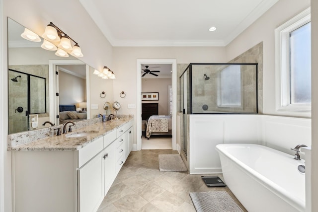 ensuite bathroom featuring a shower stall, a freestanding bath, double vanity, a sink, and connected bathroom