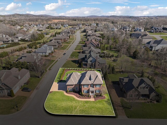 birds eye view of property with a mountain view and a residential view