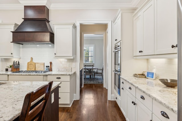 kitchen with premium range hood, ornamental molding, stainless steel appliances, and dark wood-style floors