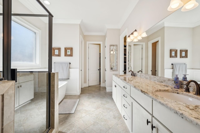 full bathroom featuring crown molding, a soaking tub, a sink, and double vanity