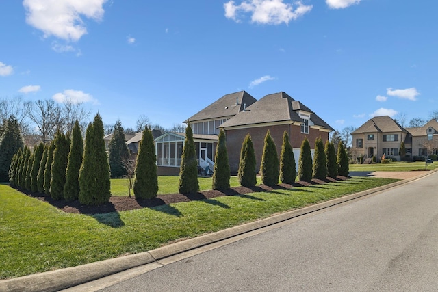 view of front of property featuring a residential view, board and batten siding, and a front yard