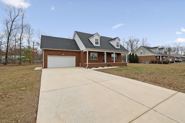cape cod home with a front lawn, driveway, covered porch, brick siding, and a garage