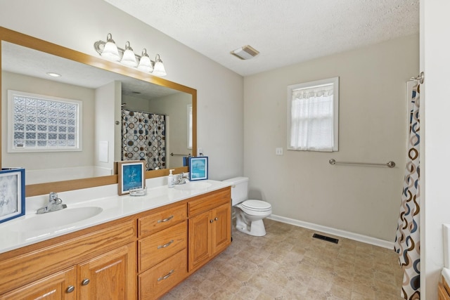 full bathroom featuring baseboards, visible vents, a sink, and double vanity