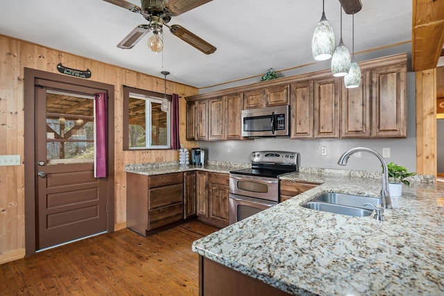 237 Cooper Ln, Smithville, TN 37166 - kitchen featuring a sink, decorative light fixtures, light stone countertops, appliances with stainless steel finishes, and ceiling fan