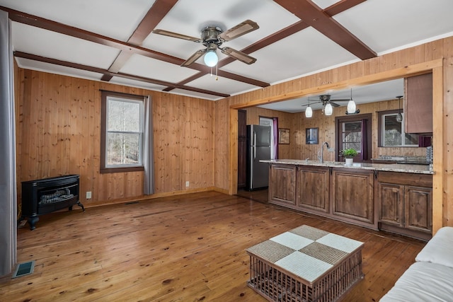 237 Cooper Ln, Smithville, TN 37166 - living area with beam ceiling, coffered ceiling, ceiling fan, wooden walls, and a wood stove