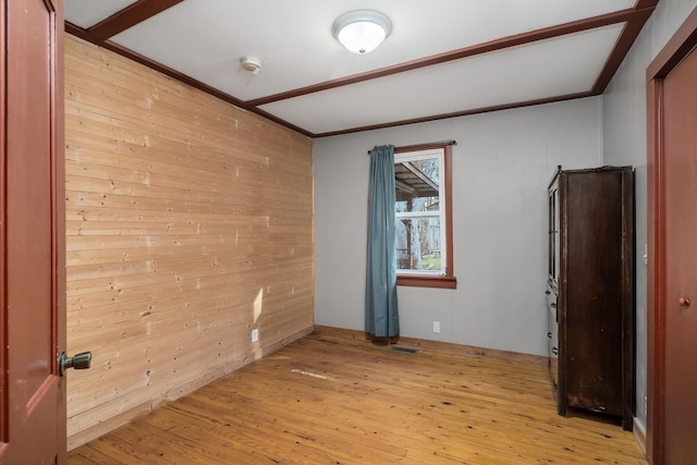237 Cooper Ln, Smithville, TN 37166 - spare room featuring wood walls, ornamental molding, visible vents, and light wood-type flooring
