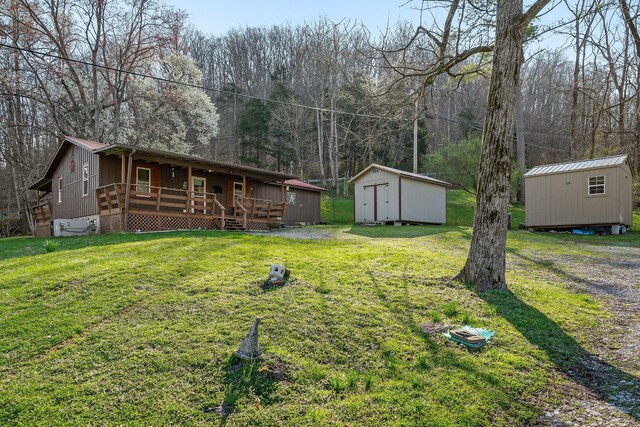 237 Cooper Ln, Smithville, TN 37166 - view of yard featuring an outdoor structure, a porch, and a storage unit