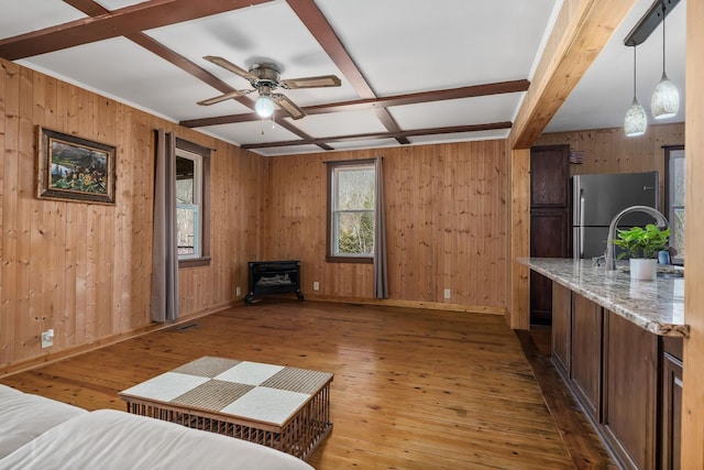 237 Cooper Ln, Smithville, TN 37166 - living area with ceiling fan, wood walls, baseboards, and light wood-style flooring
