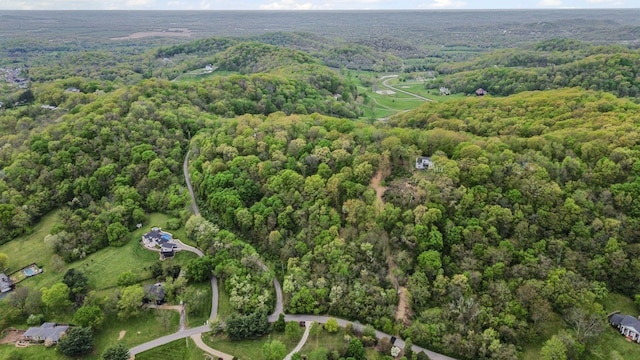 birds eye view of property with a wooded view