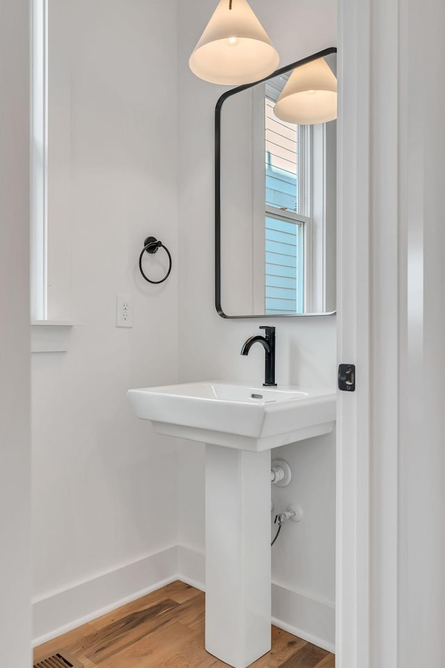 bathroom featuring wood finished floors and baseboards
