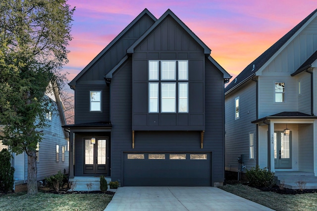 view of front facade featuring concrete driveway, an attached garage, and board and batten siding