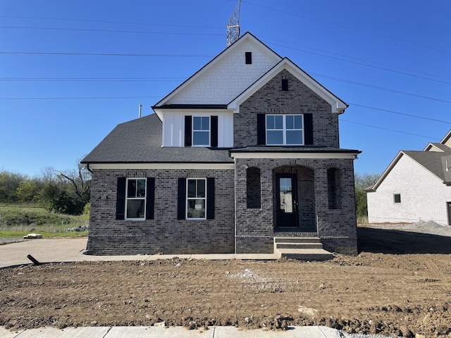 view of front of property featuring brick siding and a porch