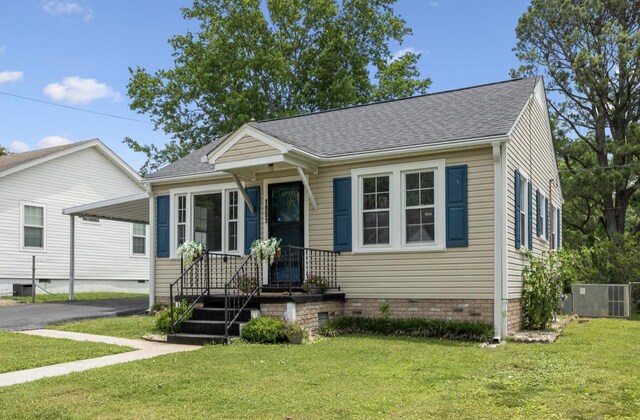 1901 Cherry St, Columbia, TN 38401 - view of front of property with a shingled roof, a carport, driveway, central AC unit, and a front lawn
