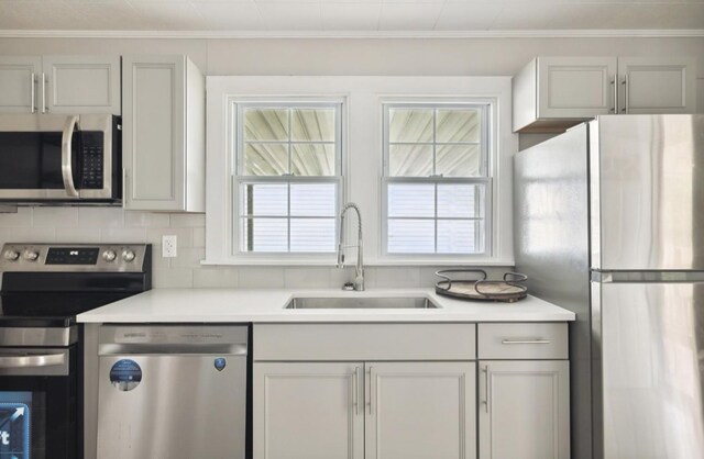 1901 Cherry St, Columbia, TN 38401 - kitchen with appliances with stainless steel finishes, a sink, light countertops, and backsplash