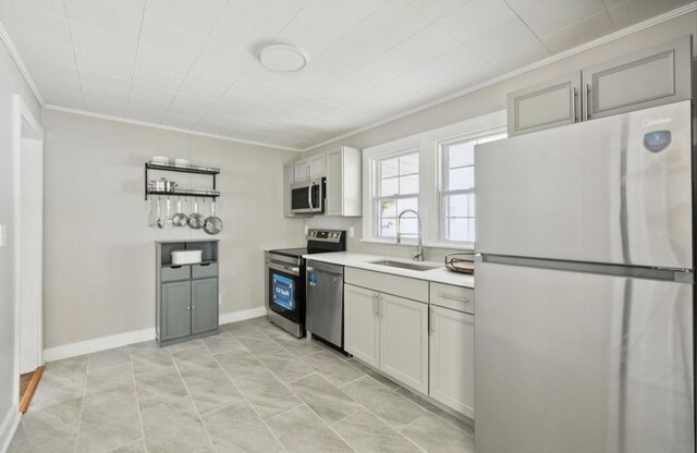 1901 Cherry St, Columbia, TN 38401 - kitchen with stainless steel appliances, ornamental molding, a sink, light countertops, and gray cabinets