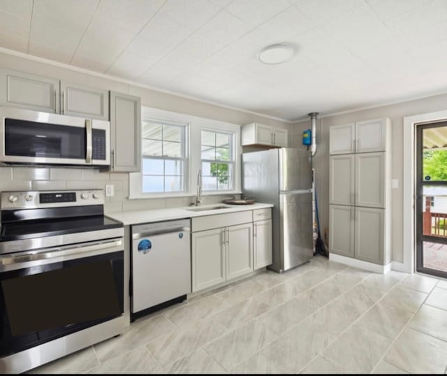1901 Cherry St, Columbia, TN 38401 - kitchen with stainless steel appliances, a sink, plenty of natural light, light countertops, and ornamental molding
