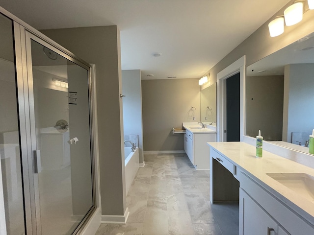 bathroom featuring a bath, a sink, two vanities, and a stall shower