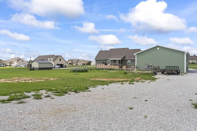 1132 Richland Farms Dr, Manchester, TN 37355 - rear view of house with board and batten siding, a lawn, a residential view, fence, and an outdoor structure