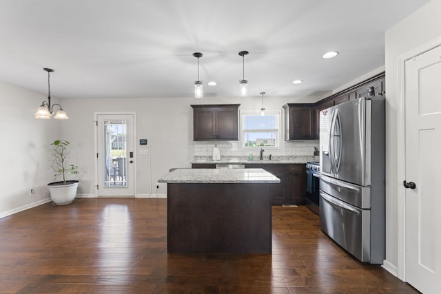 1132 Richland Farms Dr, Manchester, TN 37355 - kitchen with dark brown cabinetry, appliances with stainless steel finishes, a center island, light stone counters, and recessed lighting