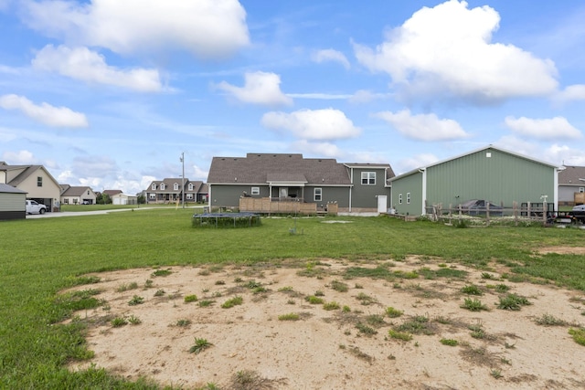 1132 Richland Farms Dr, Manchester, TN 37355 - rear view of house featuring a lawn, a trampoline, and a residential view