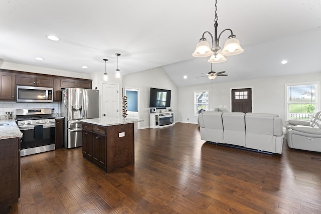 1132 Richland Farms Dr, Manchester, TN 37355 - kitchen with decorative light fixtures, dark brown cabinets, open floor plan, and appliances with stainless steel finishes