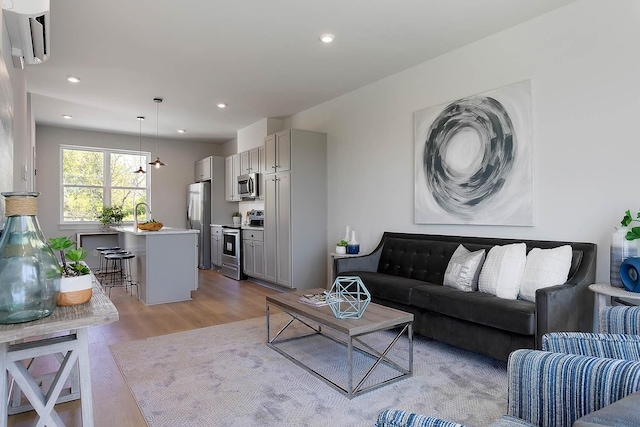 living area featuring recessed lighting and light wood-style floors