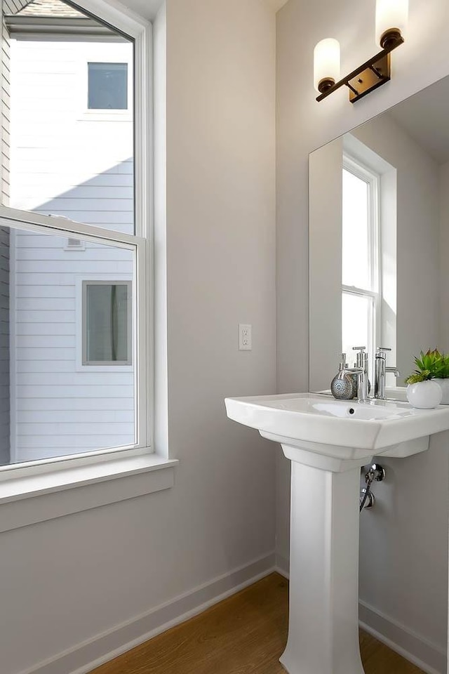 bathroom featuring wood finished floors and baseboards