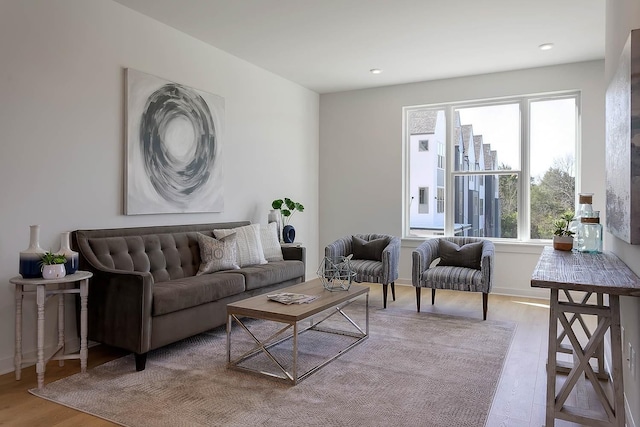 living area with recessed lighting, wood finished floors, and baseboards