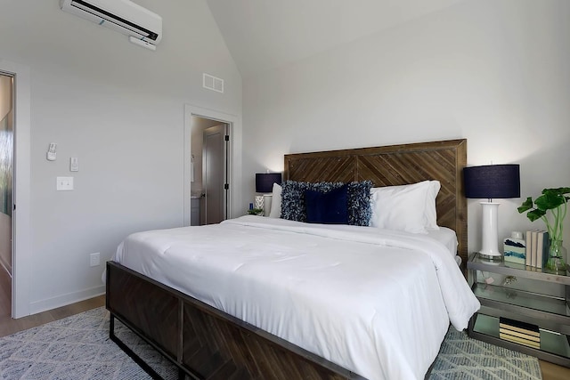 bedroom with a wall mounted air conditioner, wood finished floors, baseboards, lofted ceiling, and visible vents